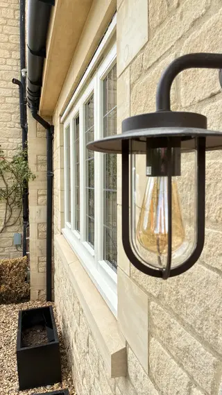 Black lantern mounted beside a white-framed exterior door