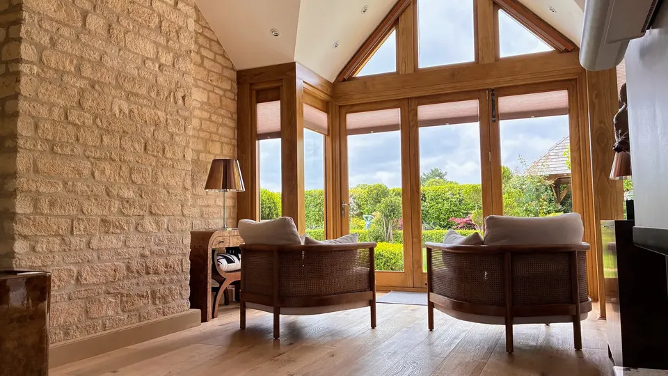 Broadway — May 2026 Project — interior vaulted living room with exposed Cotswold stone wall