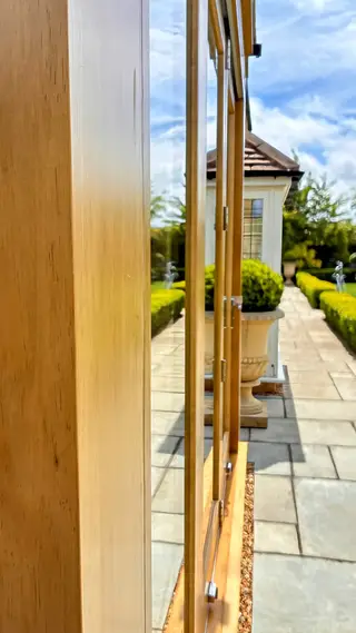 Close view along the glazed door frame towards the terrace