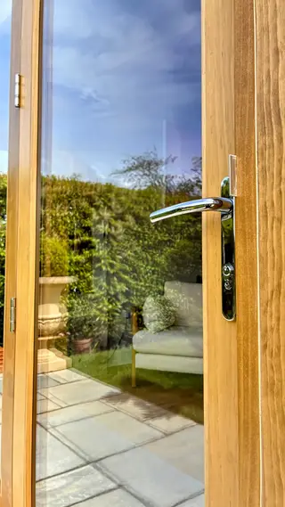 Close-up of a polished handle on a glazed door