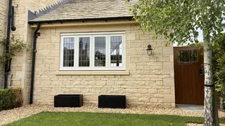 Stone side extension viewed across the lawn