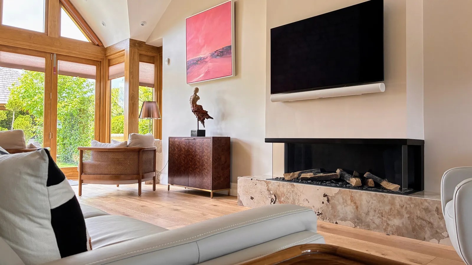 Charnwood House — interior living area with stone fireplace and vaulted ceiling