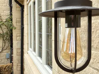Black lantern mounted beside a white-framed exterior door
