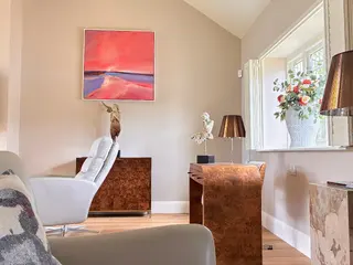 Finished sitting room with neutral walls and oak flooring
