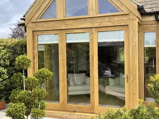Front view of the oak-framed extension with full-height glazed doors