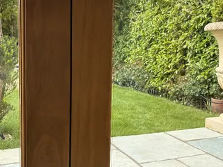 Oak-framed glazed doors opening onto the stone terrace