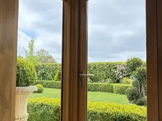 Garden seen through full-height oak-framed glazed doors