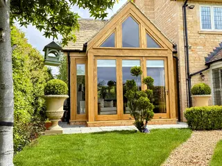 Oak-framed glazed apex extension viewed from the front garden