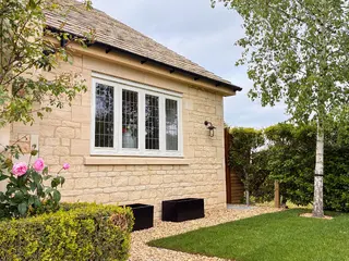 Stone side extension with leaded windows and a tiled roof