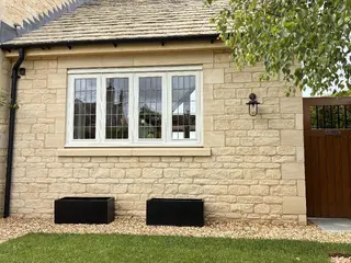 Stone side extension viewed across the lawn